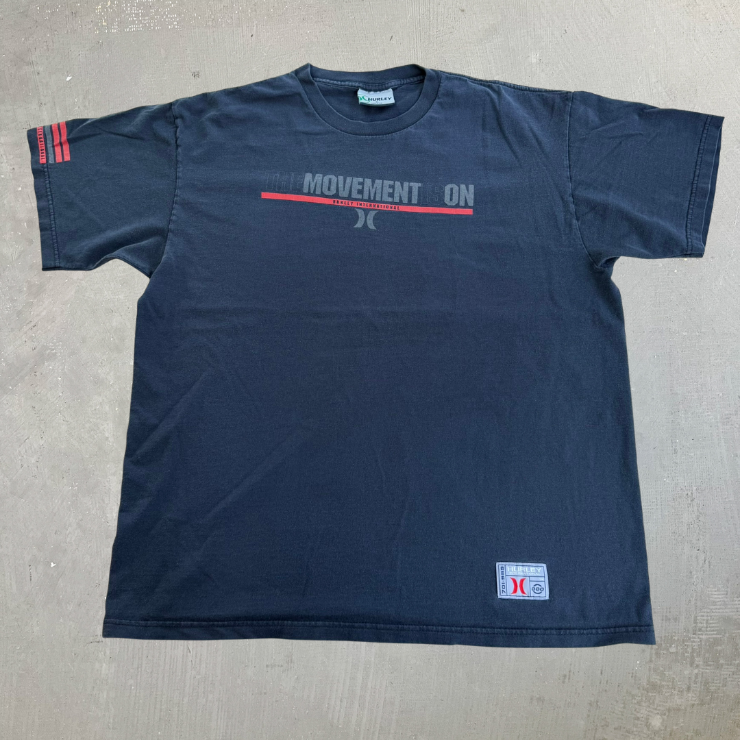 J- Vintage Hurley International The Movement Is On Graphic Text Made In USA Tee - XL