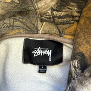 J- Vintage Stussy Embroidered Cursive Text Logo Real Tree Camo Hoodie - L
