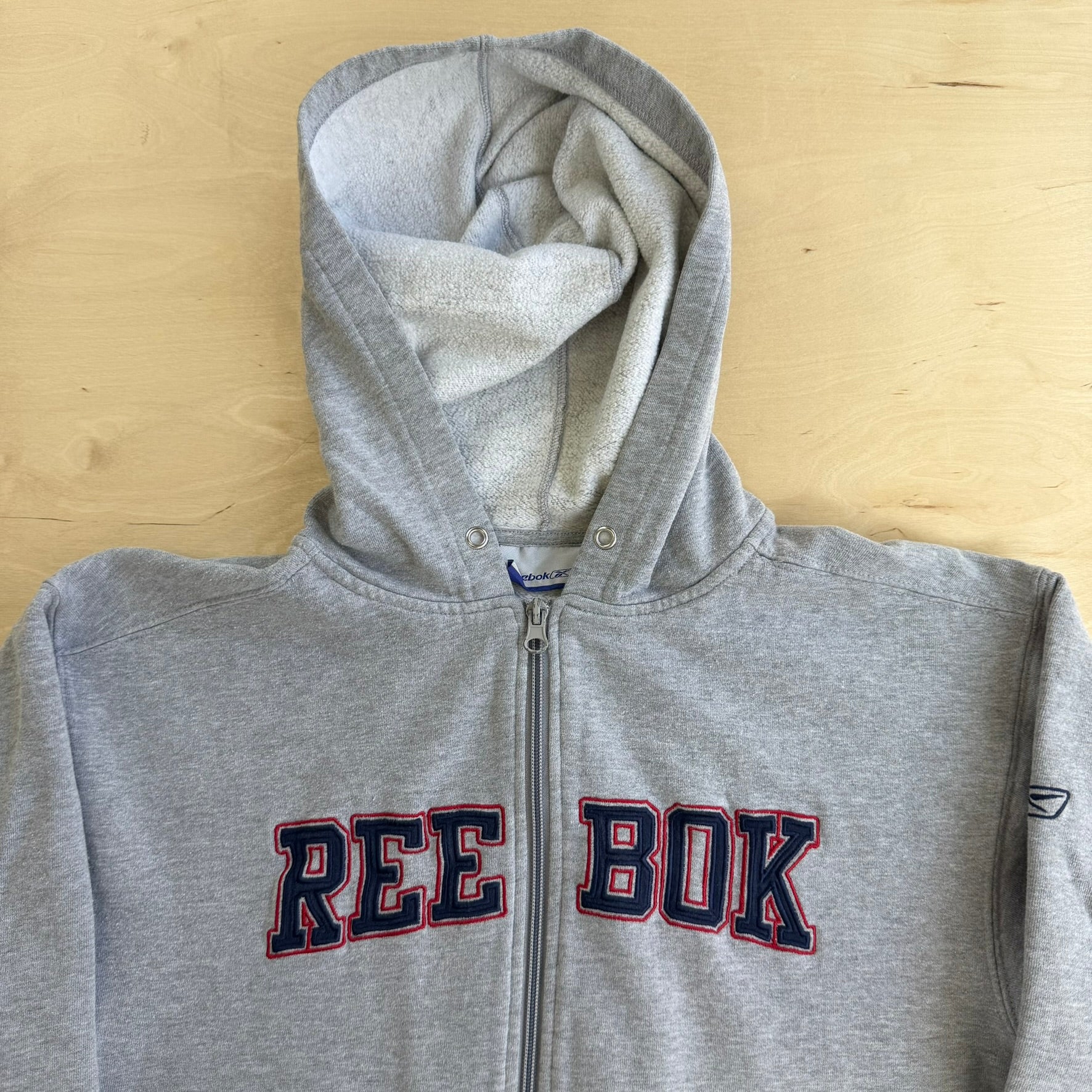 J- Vintage Reebok Embroidered Text Zip Up Hoodie - XL (fits M)